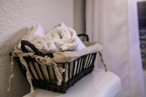 a basket filled with towels on a wall at Long Beach Home Beautiful Private area in Long Beach