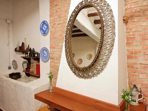 a mirror on a wall with a wooden table at Casa rural de la Abuela in Cadreita
