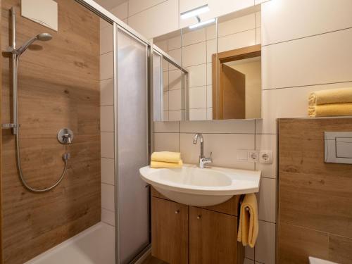 a bathroom with a sink and a shower at Haus Alpenrose in Waidring