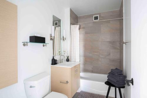 a bathroom with a toilet and a sink and a shower at Brooklyn bridge view residence in New York