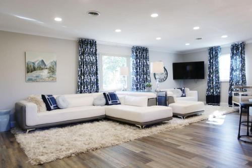 a living room with a white couch and blue curtains at 5 KING BEDS, 1Q 1Full P/O NEWLY REMODELED 2800 sq ft in Knoxville