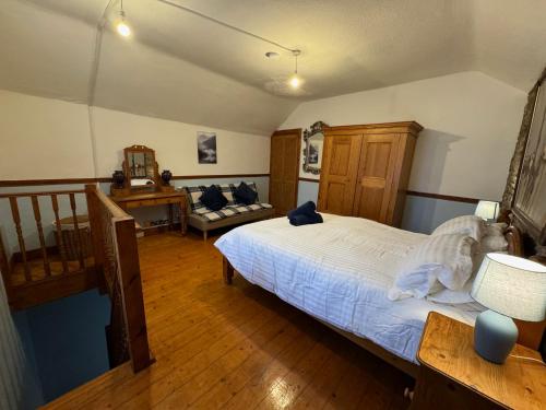 a bedroom with a large bed and a desk at Compton House 1 in Conwy