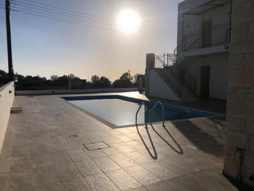 a swimming pool in the backyard of a house at Daniel's Hotel Apartments in Paphos City