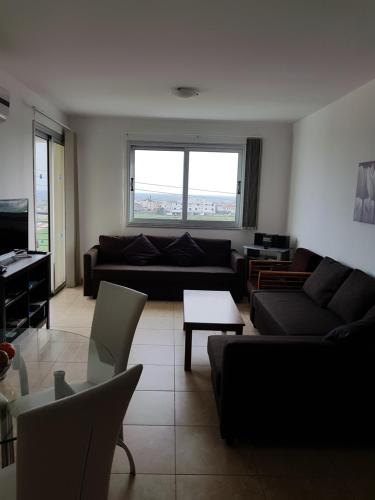 a living room with a couch and a table at Holiday Apartment with Sea View (0002913) in Paralimni