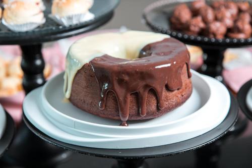 a chocolate cake on a plate with chocolate icing at ibis Presidente Prudente Manoel Goulart in Presidente Prudente