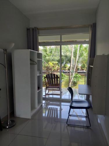 a kitchen with a table and a chair and a window at Hotel PZ Country Club & Conference Center in San Isidro