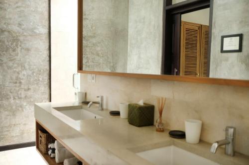 a bathroom with a large sink and a mirror at Wave House - Surf Camp in Canggu