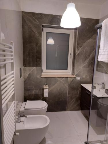 a bathroom with a sink and a toilet and a mirror at Tenuta Casa Arsa in Montemarano