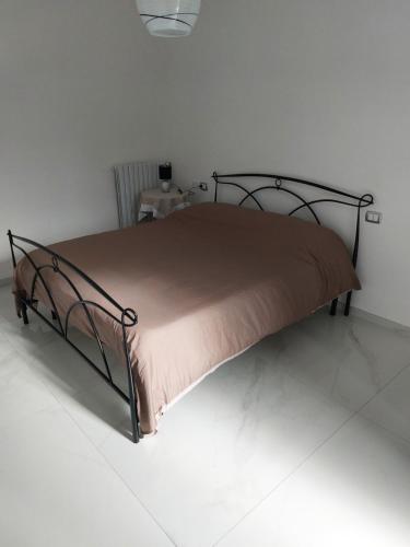 a bedroom with a bed with a metal frame at Tenuta Casa Arsa in Montemarano