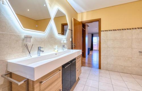 a bathroom with a sink and a mirror at Villa Redonda Jacuzzi Heated Pool in Albufeira