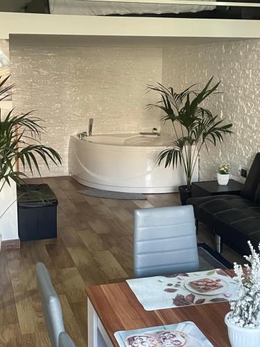 a living room with a bath tub and a table at Maison Damas in Barletta