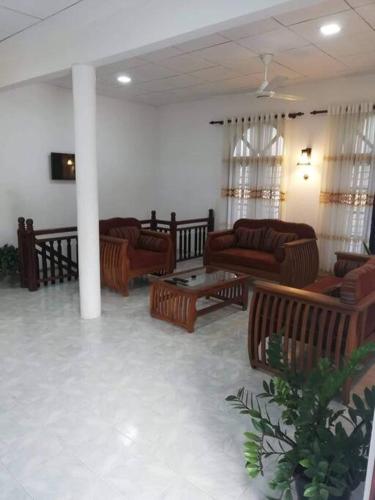 a living room with couches and tables at The Travel Inn in Ahangama