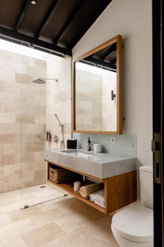a bathroom with a sink and a shower at Wave House Boutique Surf Retreat - Adults Only in Canggu
