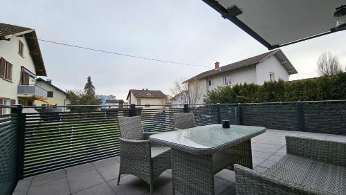 a patio with a table and chairs and a fence at FeWo in der Kiese Hard in Hard