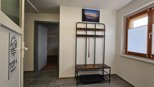 a hallway with a shelf in a room with a window at FeWo in der Kiese Hard in Hard