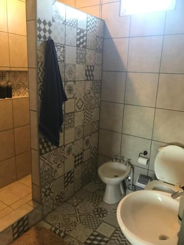 a bathroom with a toilet and a sink at Casa de campo “Doña Elisa” in San Andrés de Giles