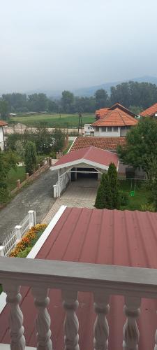 a view from a balcony of a house with a red roof at Holiday Home Peaceful Retreat in Visoko