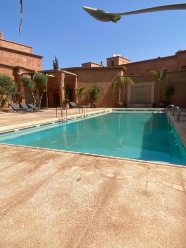 a swimming pool in the middle of a house at Villa les oliviers in Marrakesh