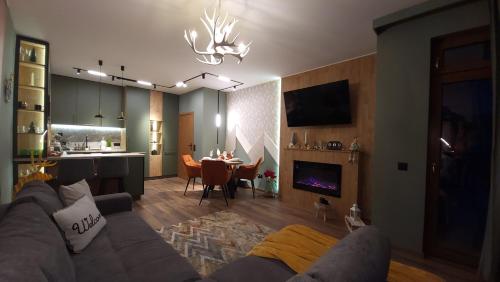 a living room with a couch and a dining room at Pinewood ANG premium luxurious apartment 15 in Borovets