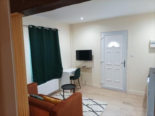 a living room with a door and a chair and a desk at Appartement à Evreux à 10 minutes de la gare et de la Cathédrale in Évreux
