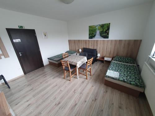 a room with a table and a bed and a table and chairs at UBYTOVANIE NITRA – Lužianky Privát Iveta in Šarlužky-Kajsa