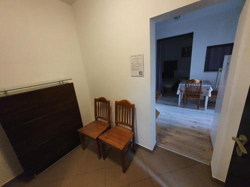 a room with two chairs and a dining room at UBYTOVANIE NITRA – Lužianky Privát Iveta in Šarlužky-Kajsa