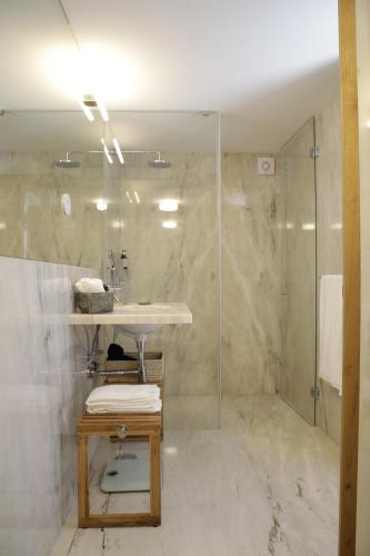 a bathroom with a sink and a shower at Gerês - Leiras do Tempo - Suite Alecrim in Terras de Bouro