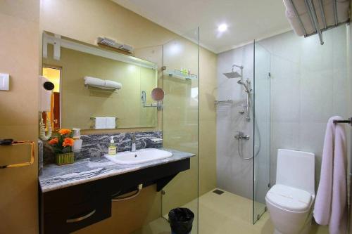Un baño con inodoro, lavabo y ducha. en Splendid Holiday Guest House, en Negombo