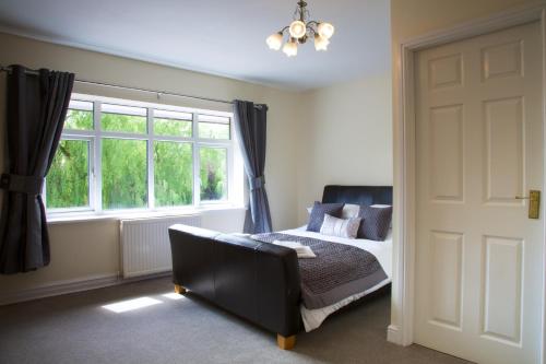 a bedroom with a bed and a window at The George Carvery & Hotel in Ripon