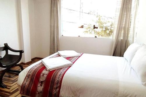 ein Schlafzimmer mit einem Bett mit zwei Büchern darauf in der Unterkunft Kaypi Samay in Cusco