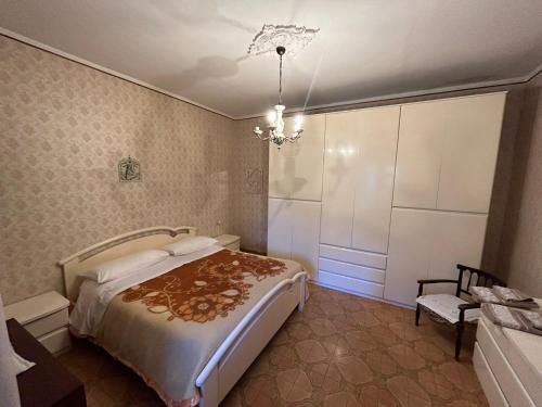 a bedroom with a bed and a chandelier at Casa Belvedere a Valle San Martino di Spoleto in Spoleto