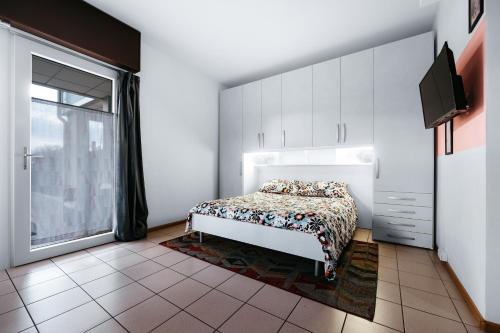 a bedroom with a bed and a large window at Nest Eco Guesthouse in Udine