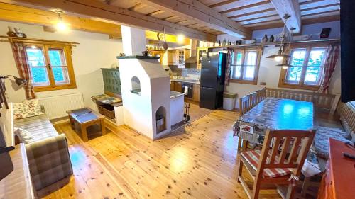 a kitchen with a stove in the middle of a room at Chalupa pod lipou in Zázrivá