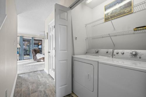 a white laundry room with a washer and dryer at Little River-condo-sleeps 10 By Hostique in Little River