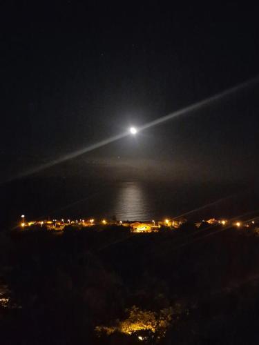 a moonlit view of a city at night at Villa Alta Vista in São Jorge