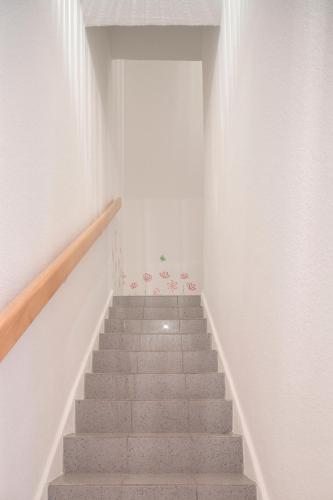 a staircase in a room with white walls and a stair case at Jovles Beisken GmbH in Münster