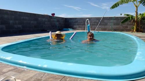deux filles jouant dans une piscine dans l'établissement Sobradinho Nova Torres, 