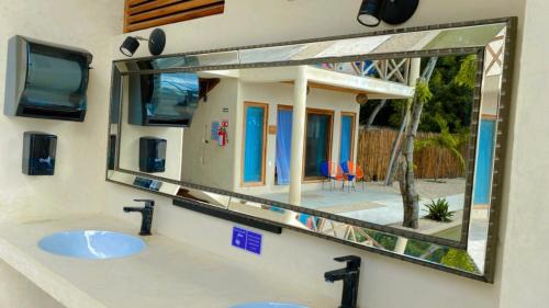a bathroom with two sinks and a large mirror at Hotel & Eco Cabañas Azul María Bacalar- Gratis Club de playa in Bacalar