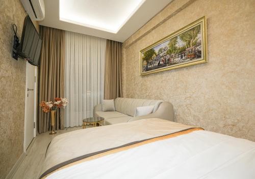 a hotel room with a bed and a couch at Luxury Medea Taksim Hotel in Istanbul