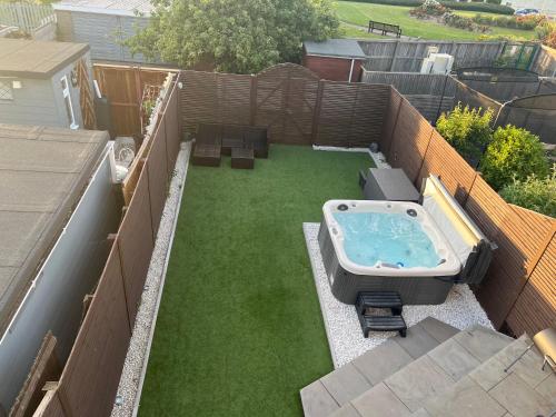 an aerial view of a backyard with a hot tub at Broadway Beach Home with Hot tub in Herne Bay
