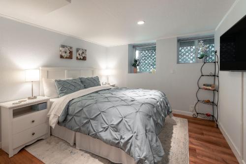 a bedroom with a bed and a flat screen tv at Laurelhurst - Cozy 1 Bedroom Apt Near Children’s Hospital and UW in Seattle