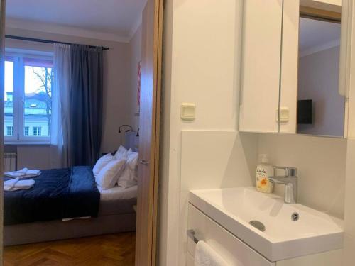 a bedroom with a bed and a sink and a window at Great place to stay in Warsaw in Warsaw