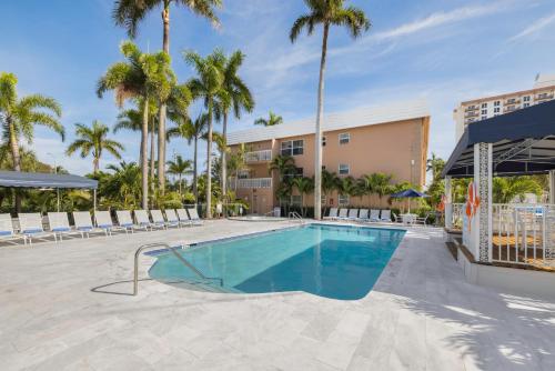 a swimming pool at a resort with palm trees at Coconut Bay Resort in Fort Lauderdale
