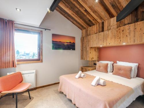 a bedroom with two beds and a chair and a window at Appartement Morzine, 4 pièces, 8 personnes - FR-1-754-11 in Morzine