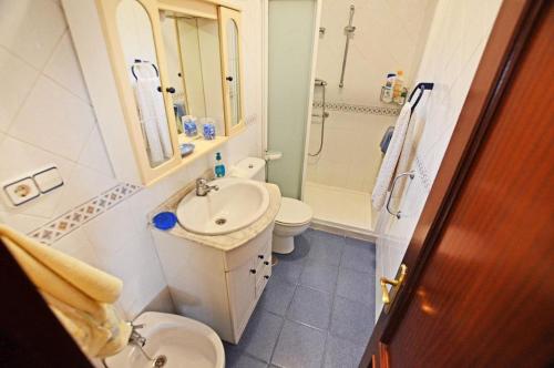 a bathroom with a sink and a toilet and a shower at APARTAMENTO EN CANDAS in Candás