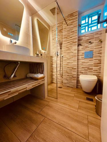 a bathroom with a shower and a toilet and a sink at Blue Horizon Gem On The Port in Rafina