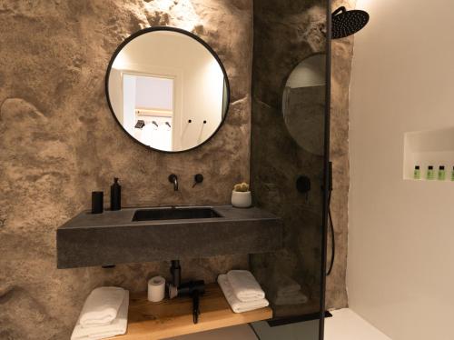 a bathroom with a sink and a mirror at Ftelia Black Villas in Elia
