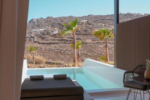 a room with a view of the desert from a house at Ftelia Black Villas in Elia