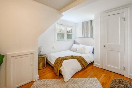 a white bedroom with a bed with a blanket on it at Trail-side Haven Retreat! Pet friendly in North Haven