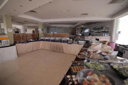 a buffet line in a restaurant with food at LUSINDA HOTEL MANAGEMENT BY ZAD in Suez